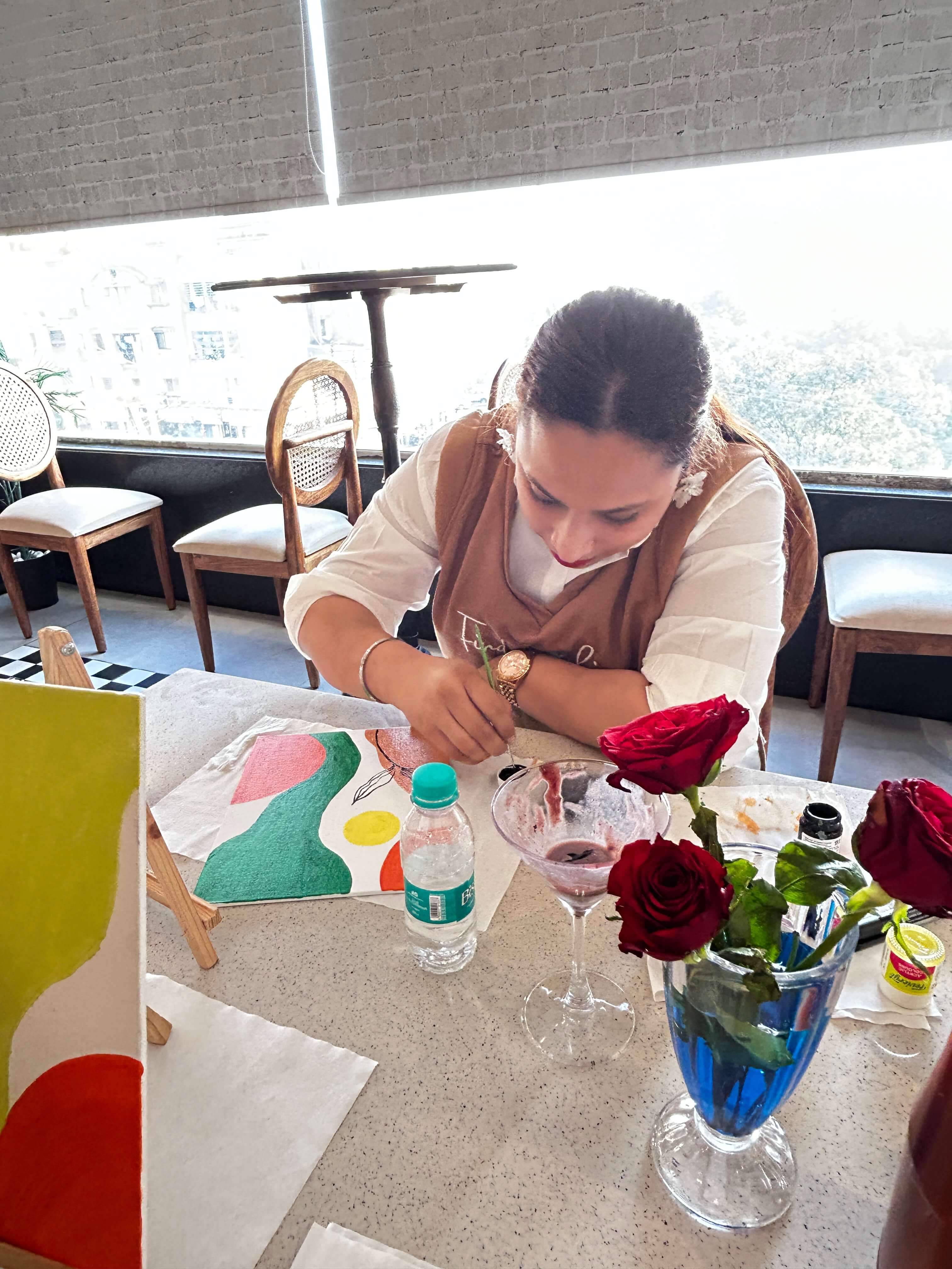 A participant creating a beautiful boho art piece in a workshop