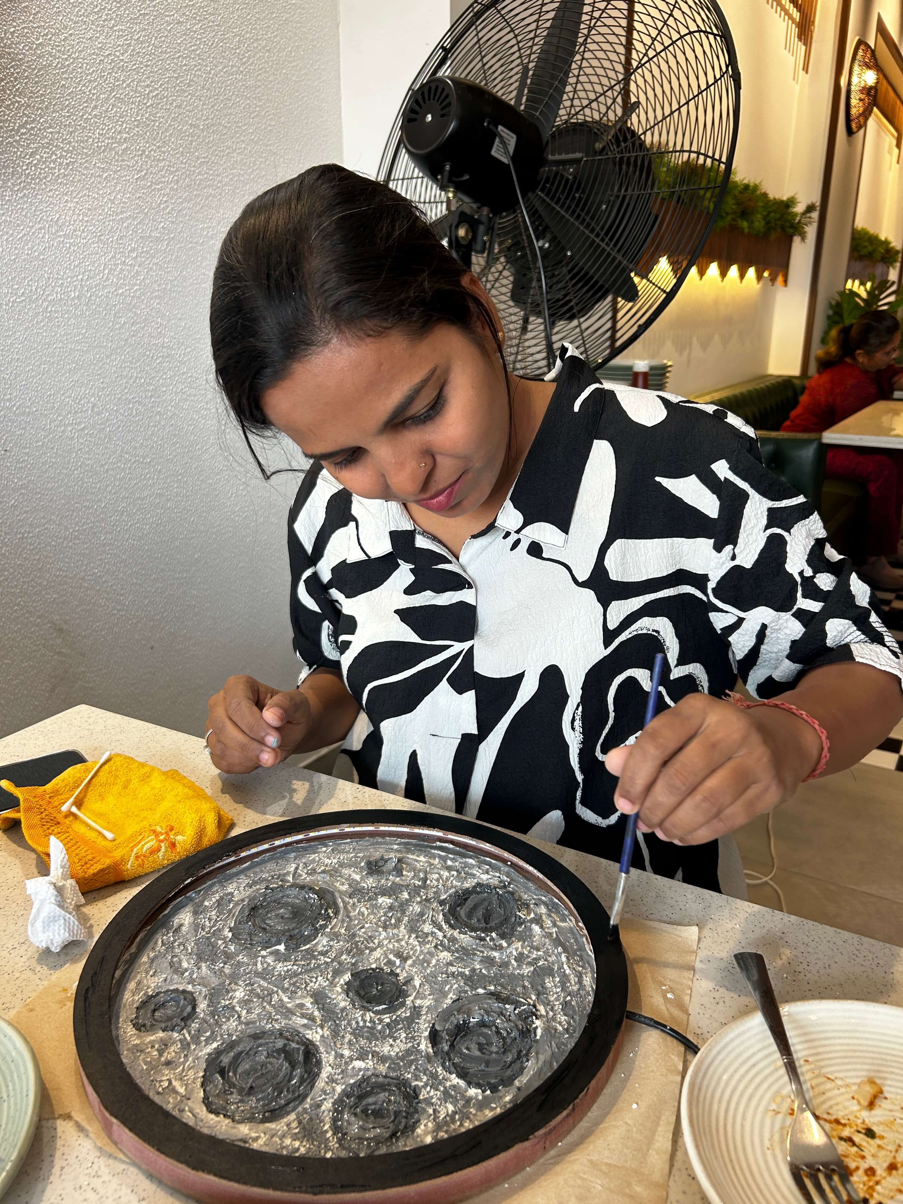 A participant holding up their creatively textured moon lamp
