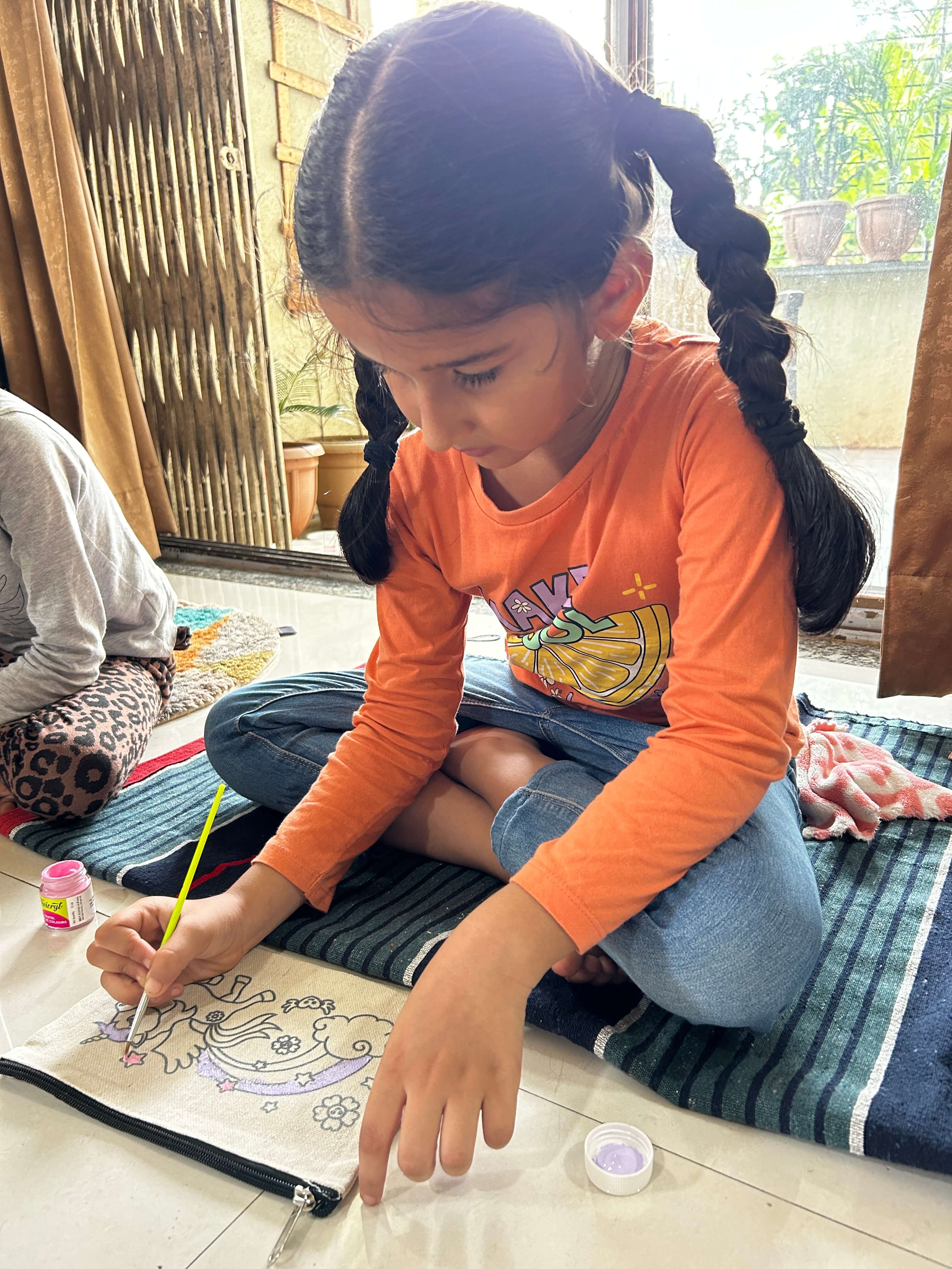 A hand-painted tote pouch with a colorful, abstract design