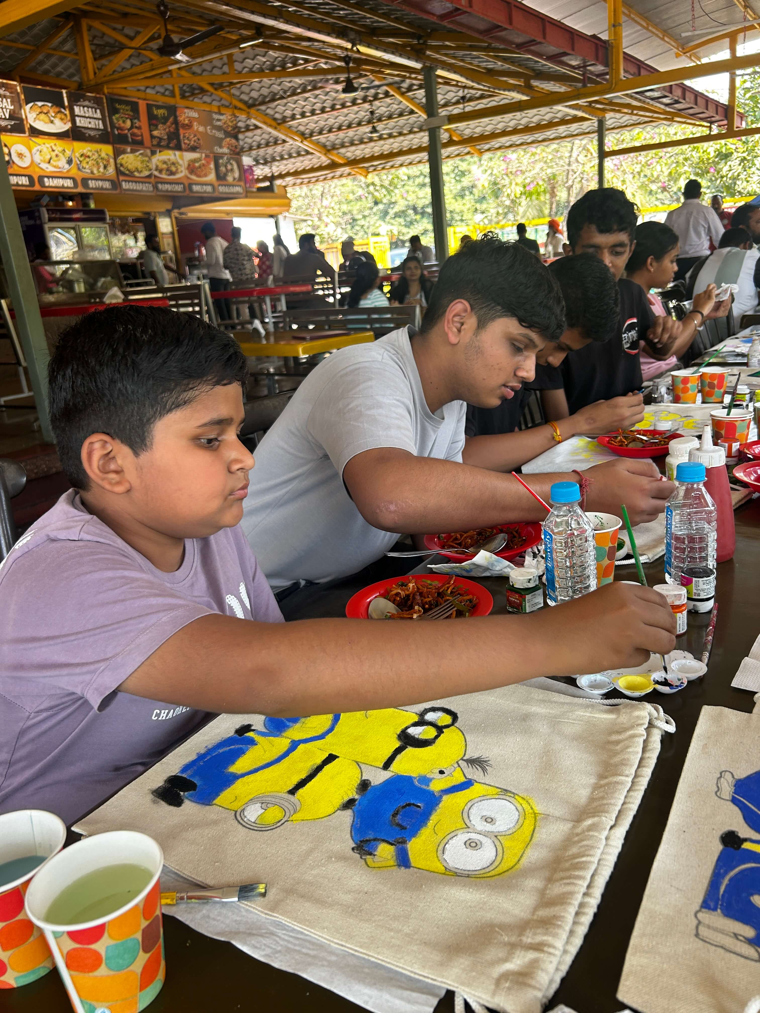 Participants showing off their creatively painted string bags