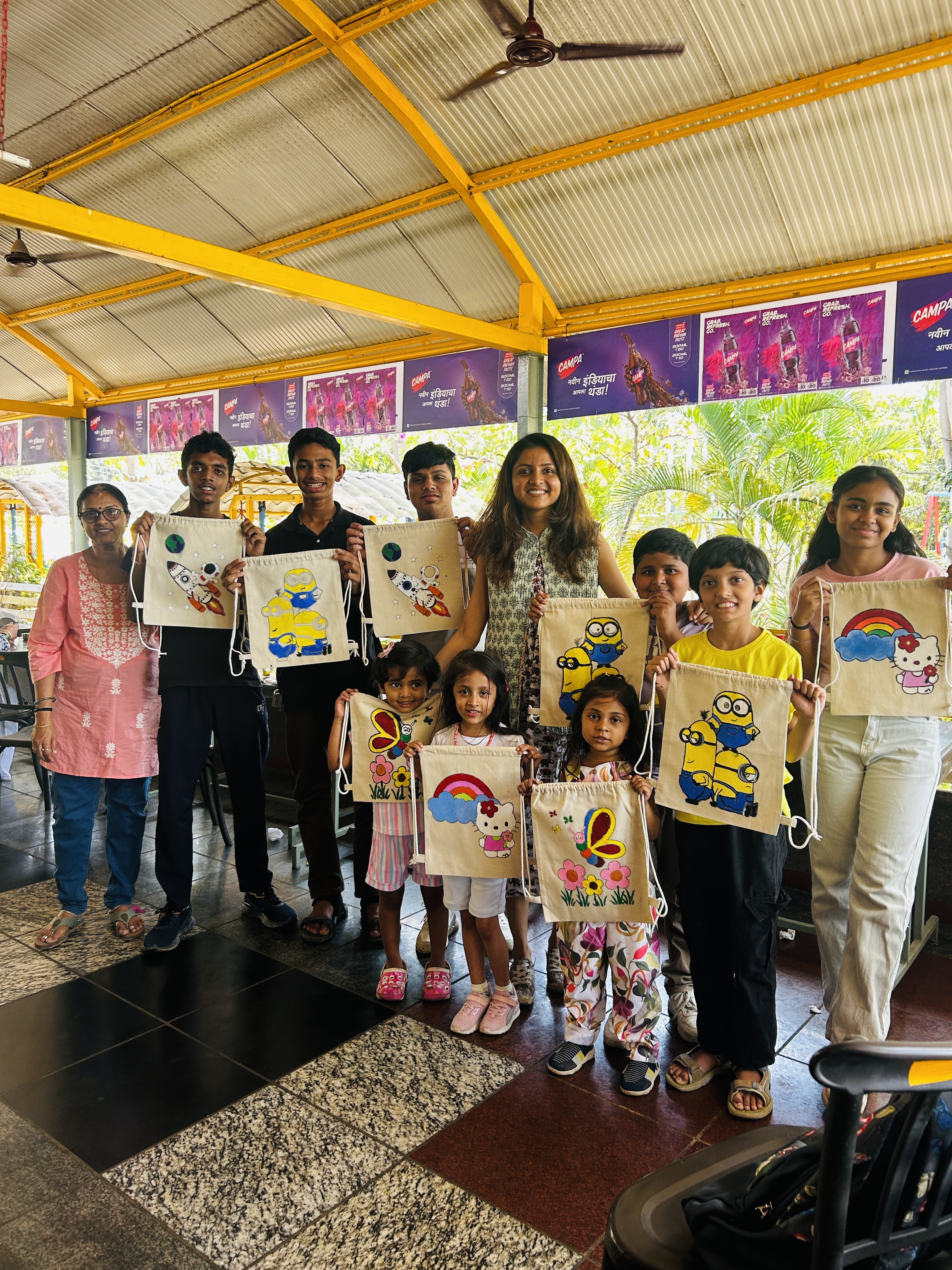 A string bag featuring a creative character painting from a workshop